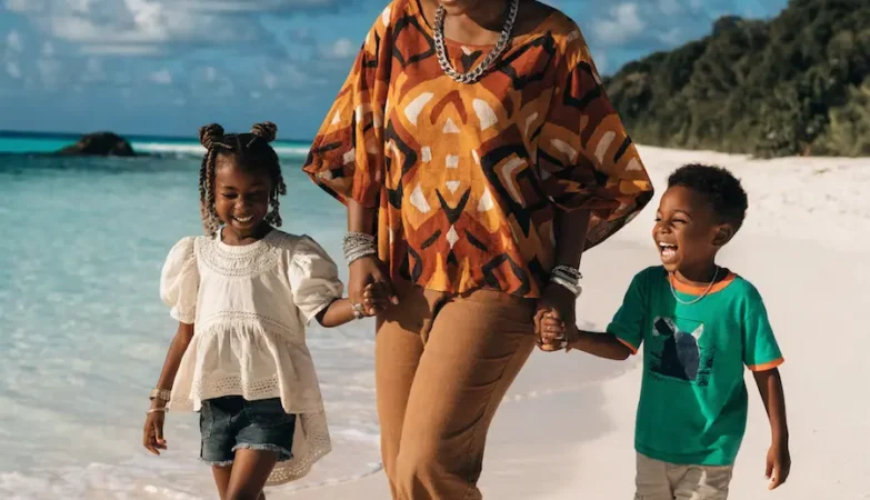 mom and kids enjoying an International destinations for your family vacation on a tropical beach